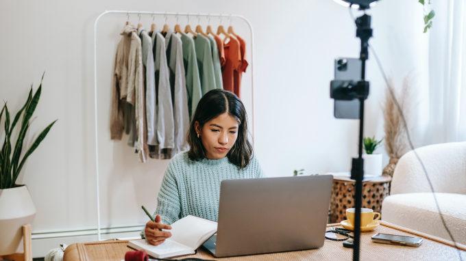 Women in a clothes store looking at a laptop