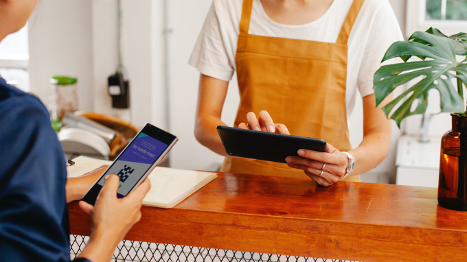 Customer using a QR card on their phone to make a payment