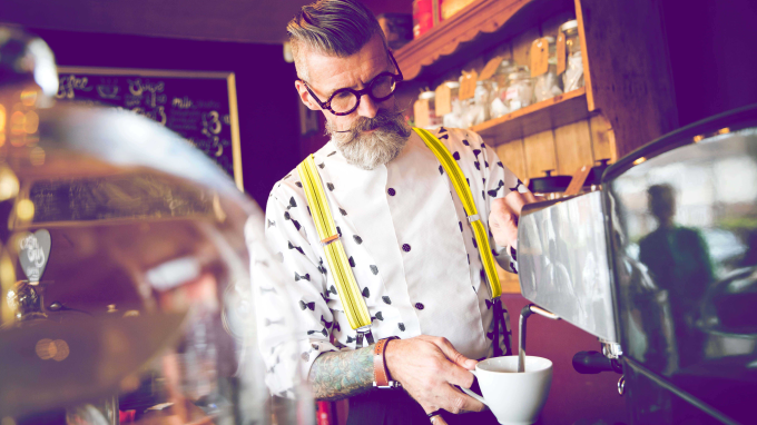 Staff in a coffee shop making coffees